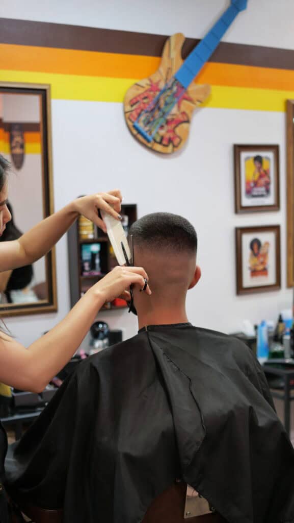 Barber giving a precise skin fade to a client at Bad Monkey Barber Shop Patong, Phuket.