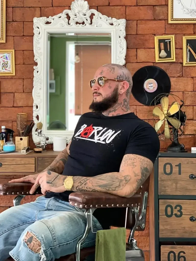 French rapper Seth Gueko relaxing after a fresh cut at Bad Monkey Barber Shop in Patong, Phuket.